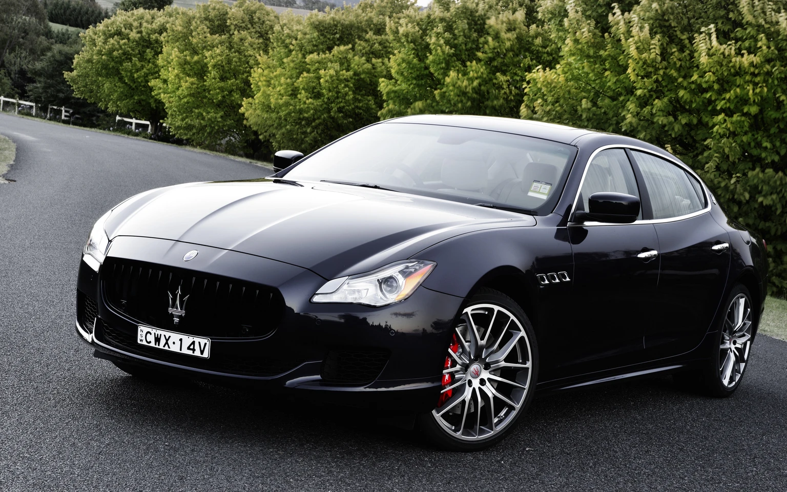 Black Luxury Sedan on Country Road